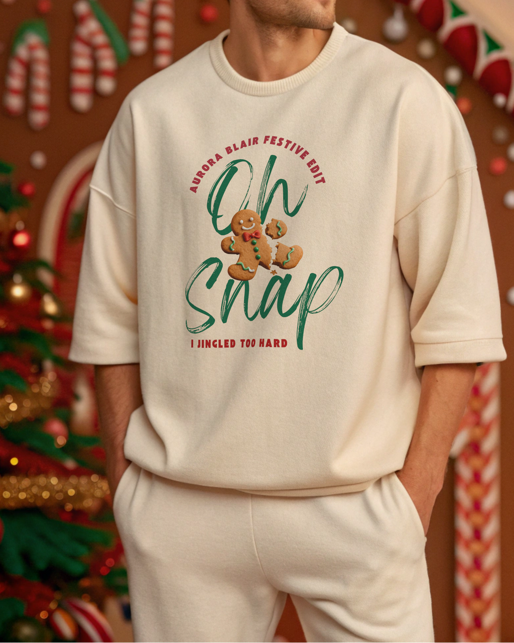 Man wearing a cream sweatshirt with Christmas-themed text and graphics in a festive setting.