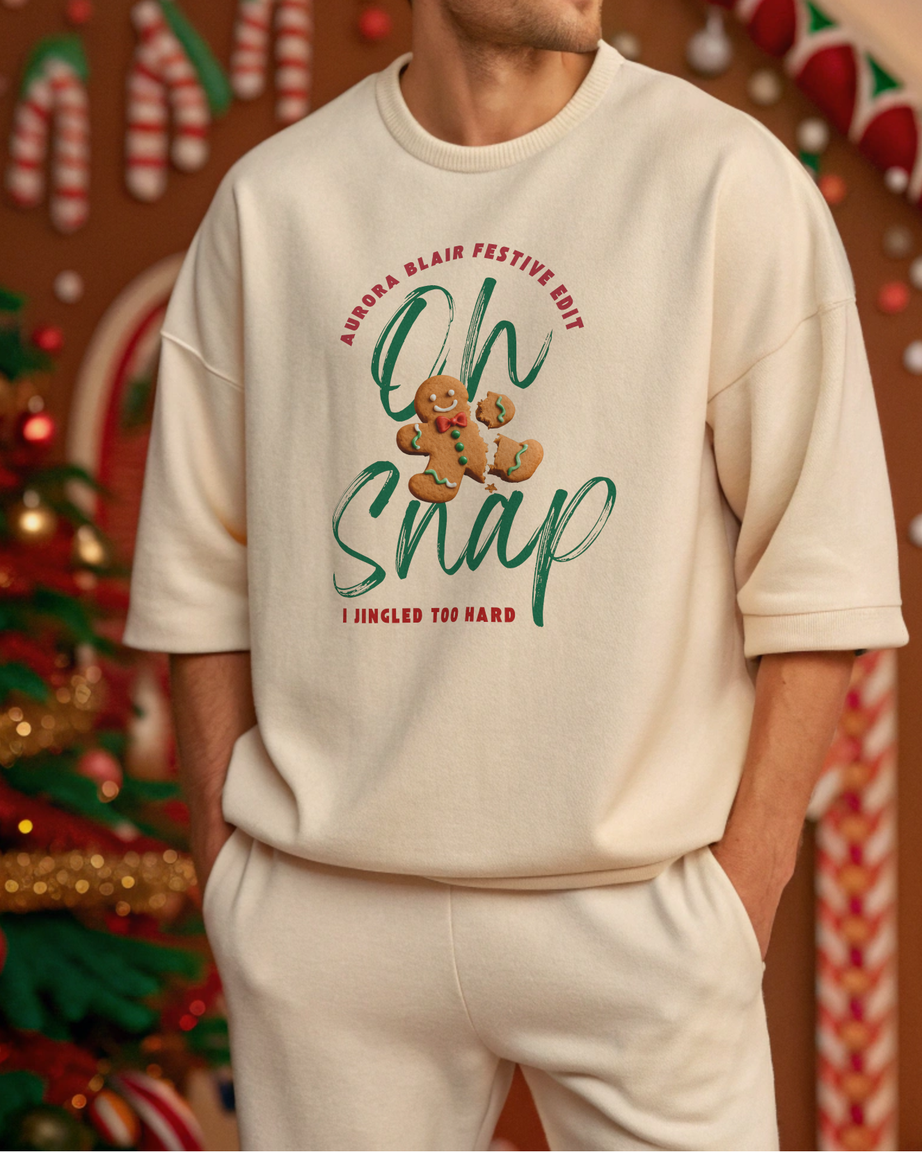 Man wearing a cream sweatshirt with Christmas-themed text and graphics in a festive setting.